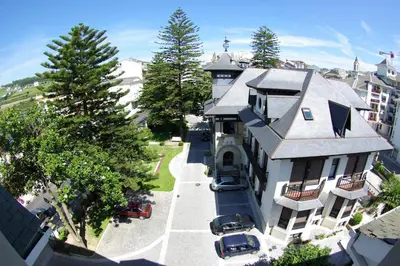 an aerial view of a building with cars parked in front at Palacio Arias in Navia