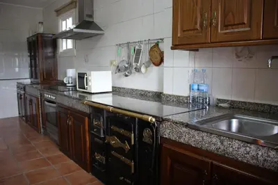 a kitchen with a sink and a counter top at Casa do Bouza Vello in Sober