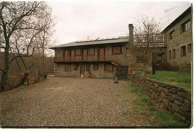 an old stone house with a stone wall at Hotel Rural El Rincón de Trefacio in Trefacio