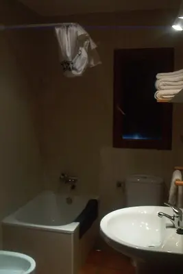 a bathroom with a sink and a tub and a toilet at Hotel Rural El Rincón de Trefacio in Trefacio
