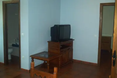 a tv sitting on a wooden stand in a room at Hotel Rural El Rincón de Trefacio in Trefacio
