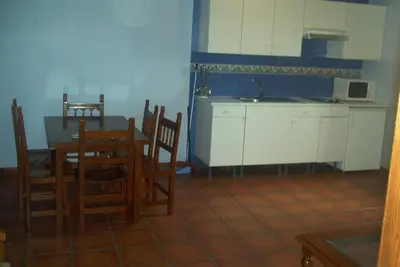 a kitchen and dining room with a table and chairs at Hotel Rural El Rincón de Trefacio in Trefacio