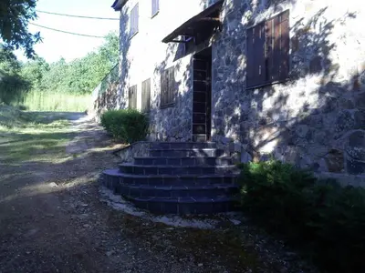 a stone building with stairs leading to a door at Hotel Rural El Rincón de Trefacio in Trefacio