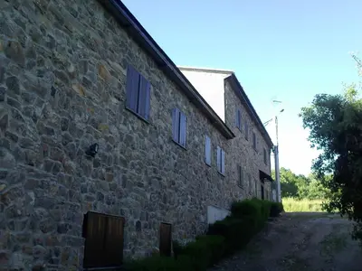 a stone building with windows on the side of it at Hotel Rural El Rincón de Trefacio in Trefacio