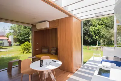 a room with a table and chairs and a large window at Bungalow Camping Los Manzanos in Santa Cruz de Oleiros