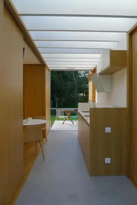 a kitchen with a large window and a table at Bungalow Camping Los Manzanos in Santa Cruz de Oleiros