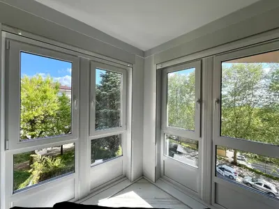 a bedroom with two beds and a large window at Castelao AP in Santiago de Compostela