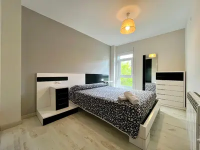 a bedroom with a bed and a window at Castelao AP in Santiago de Compostela