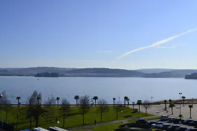 a view of a large body of water with parked cars at Hotel Alda Sada Marina in Sada