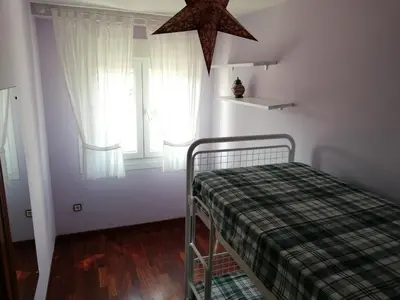 a small bedroom with a bed and a star at Apartamento Santa Marta in Santiago de Compostela