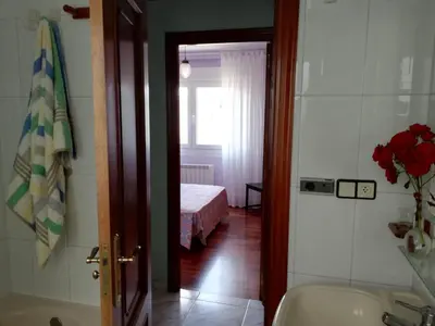 a bathroom with a tub and a bedroom with a bed at Apartamento Santa Marta in Santiago de Compostela