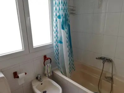 a bathroom with a tub and a sink and a shower at Apartamento Santa Marta in Santiago de Compostela