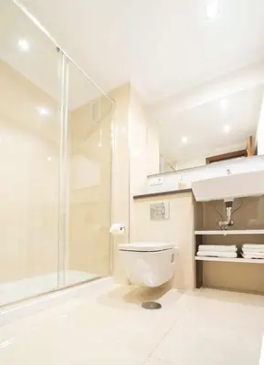 a bathroom with a toilet and a glass shower at RyS Ourense Centro PARKING Gratis in Ourense