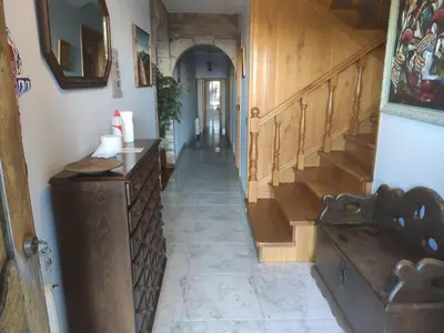 a hallway with a wooden staircase and a stair case at Albergueria Frade in O Cebreiro