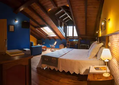 a bathroom with a sink and a toilet and towels at Micro-Hostal La Puerta del Perdón in Villafranca del Bierzo