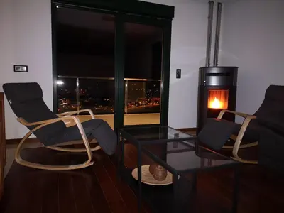 a living room with two chairs and a fireplace at Alojamientos Viveiro - El Escairo in Viveiro