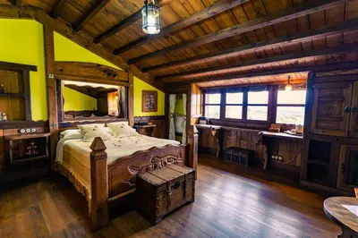 a bedroom with a bed and a desk and a bathroom at Prada a Tope - Palacio de Canedo in Canedo