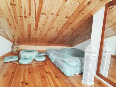 a bedroom with a bed and a wooden ceiling at A Casa das Burgas in Cuntis