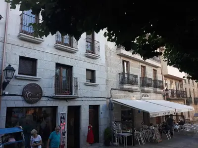 a building with people sitting outside of it at A Casa das Burgas in Cuntis