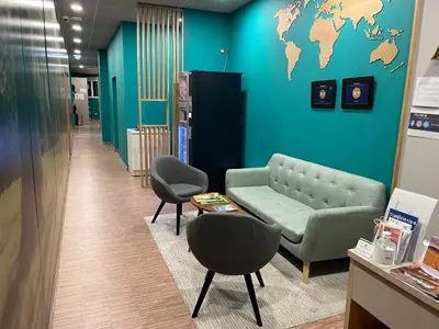 a waiting room with a couch and a map on the wall at Andaina in Sarria