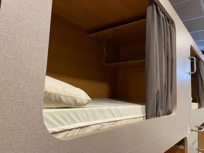 a bed in a small room with a mirror at Andaina in Sarria