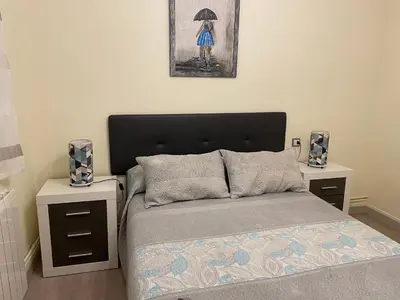 a bedroom with a bed with two nightstands and a bed sidx sidx sidx at CALLE HUERTAS Nº 17 - 1º in Lugo