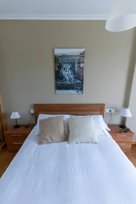 a white bed with two pillows on top of it at Puente Romana in San Ciprián