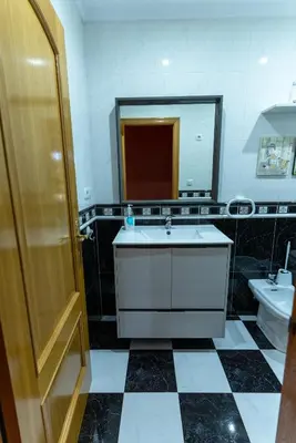 a bathroom with a sink and a mirror at Puente Romana in San Ciprián