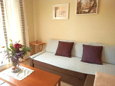 a living room with a couch and a table at A&L Playa in Viveiro