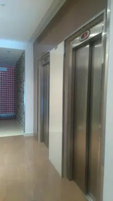 a hallway with two elevators in a building at A&L Playa in Viveiro