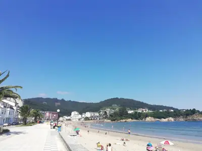 a group of people on a beach near the water at A&L Playa in Viveiro