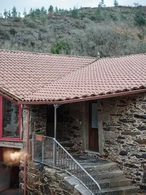 a room with a stone wall with a door at Casa Grande de Covas-Apartamentos Boutique Turísticos- Ribeira Sacra in Taboada