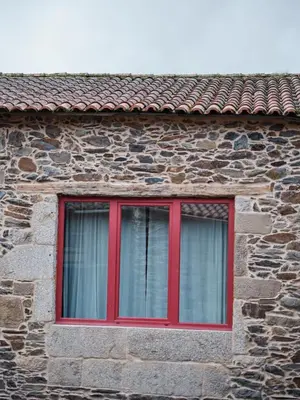 a kitchen and living room with a couch and a table at Casa Grande de Covas-Apartamentos Boutique Turísticos- Ribeira Sacra in Taboada
