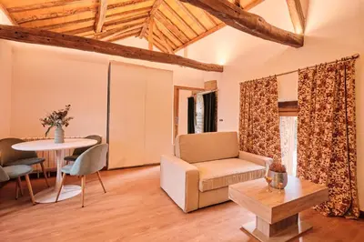 a bedroom with a bed with two slippers on it at Casa Grande de Covas-Apartamentos Boutique Turísticos- Ribeira Sacra in Taboada