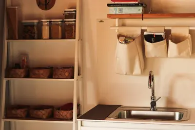 a kitchen with a sink and a shelf at Casa do Cebro Casa con piscina y jacuzzi privados in Santiago de Compostela