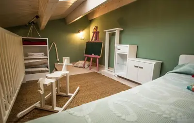 a bedroom with a bed and a desk and a chair at Casa de Abaixo in Rinlo