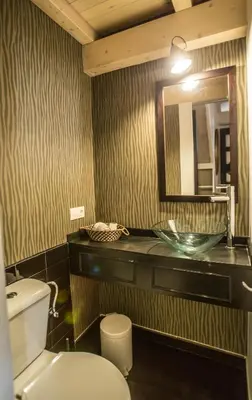 a bathroom with a sink and a toilet and a mirror at Casa de Abaixo in Rinlo