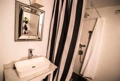 a bathroom with a sink and a shower at Casa de Abaixo in Rinlo