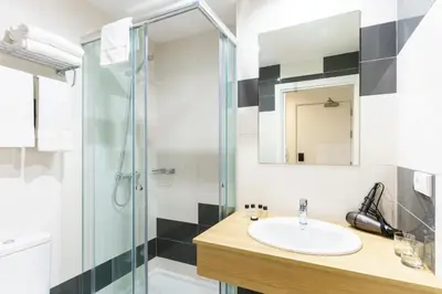 a bathroom with a sink and a shower at Hotel Concheiros in Santiago de Compostela