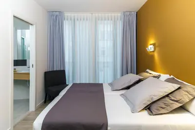 a hotel room with a large bed and a desk at Hotel Concheiros in Santiago de Compostela