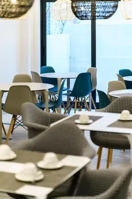 a dining room with tables and chairs and a window at Hotel Concheiros in Santiago de Compostela