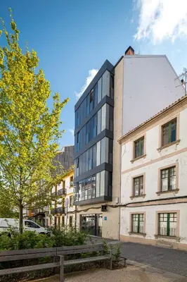 a tall building in front of a street at Hotel Concheiros in Santiago de Compostela
