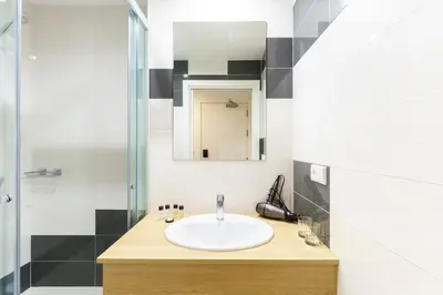 a bathroom with a sink and a shower at Hotel Concheiros in Santiago de Compostela