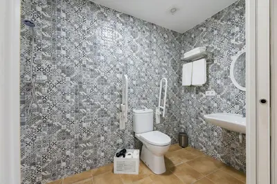 a bathroom with a toilet and a sink at Pensión Luis in Arzúa
