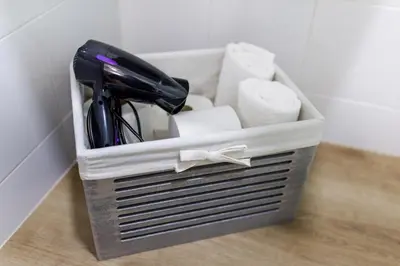 a basket filled with office items on a floor at Pensión Luis in Arzúa