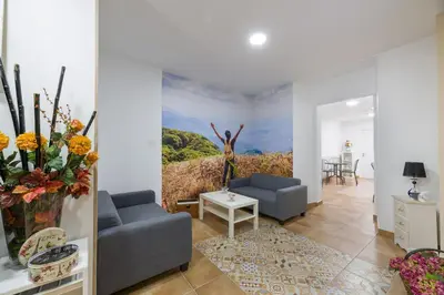 a living room with a painting on the wall at Pensión Luis in Arzúa