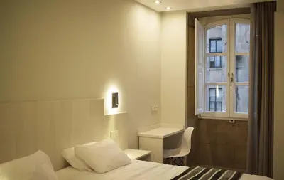 a hotel room with a bed and a window at Santa Filomena in Santiago de Compostela