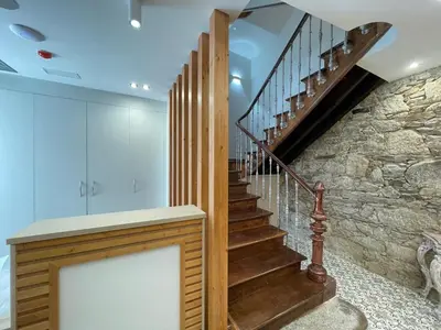 a staircase in a house with a stone wall at Santa Filomena in Santiago de Compostela