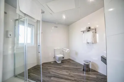 a bathroom with a toilet and a glass shower at Alojamientos rurales O Acivro in A Rúa