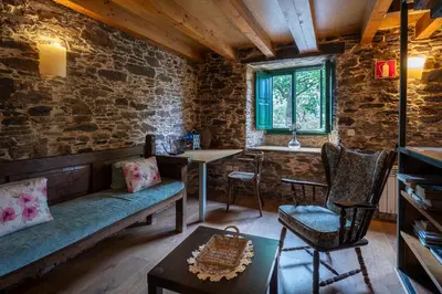 a living room with a couch and a table at Alojamientos rurales O Acivro in A Rúa